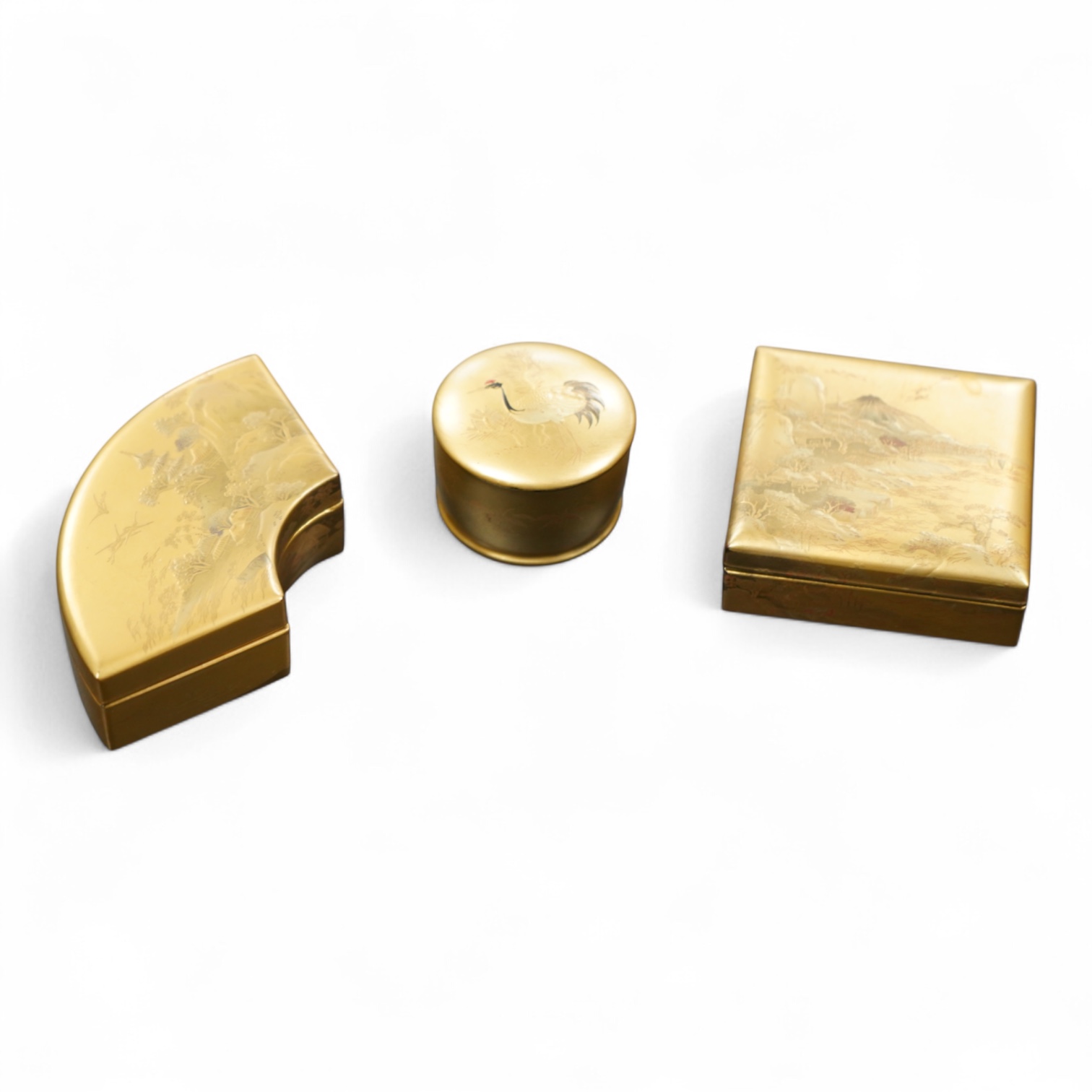 Three Japanese gilt lacquer boxes, one depicting Mount Fuji, largest 9cm wide
